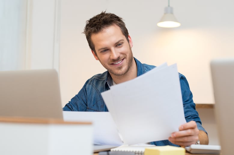 Man reading report at his desk