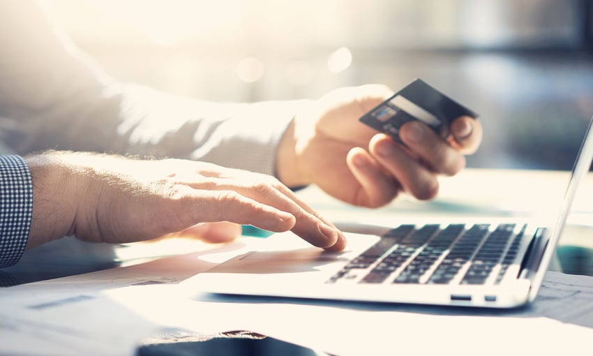 Man entering credit card information on his laptop