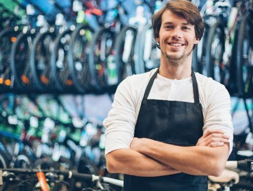 Happy bicycle shop owner