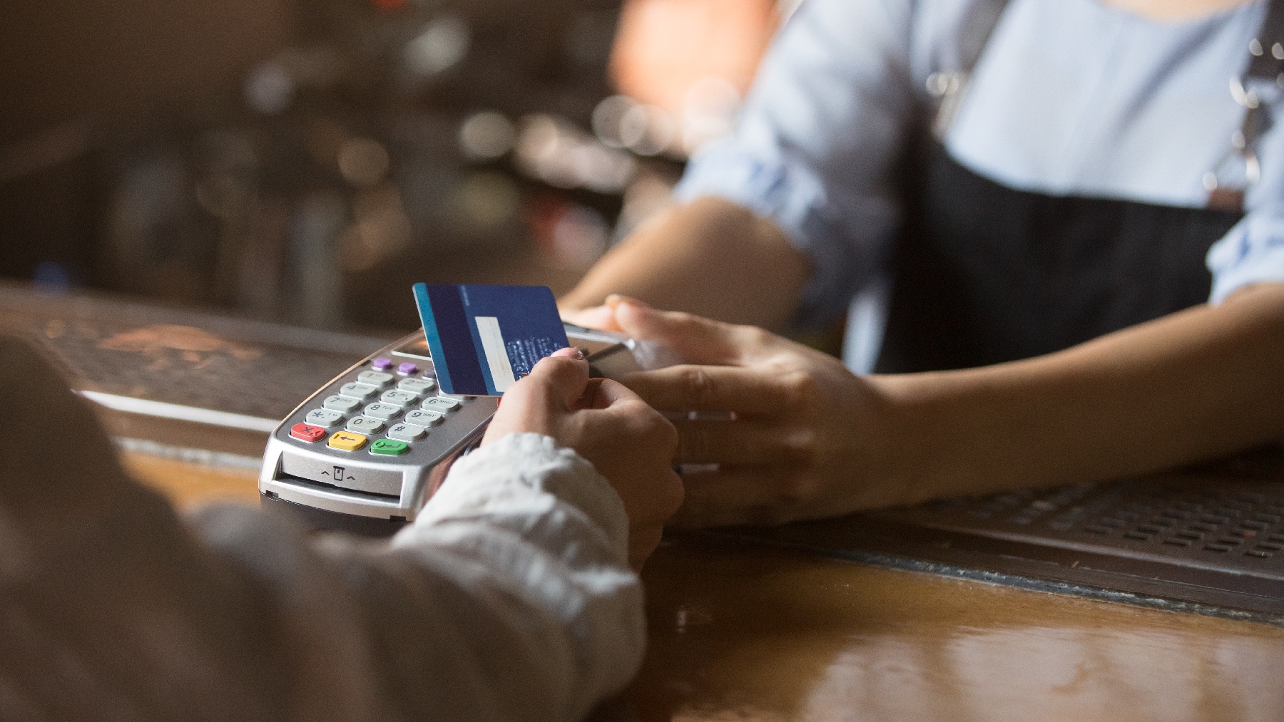 A small business owner is accepting a credit card payment from one of his customers