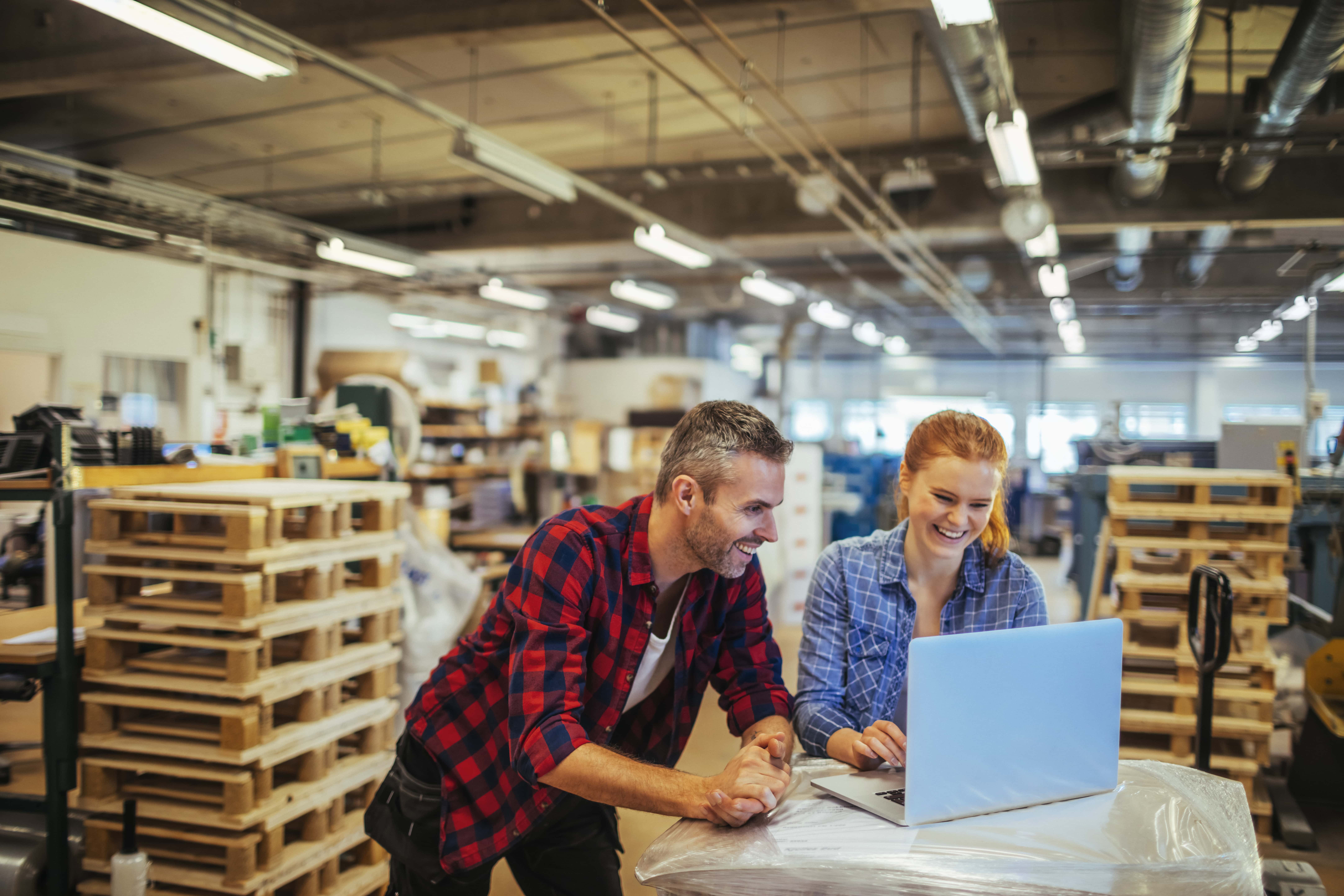 Two business owners looking at their laptop.