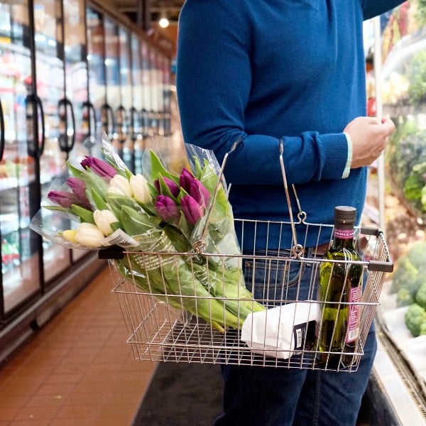 Man grocery shopping at a small business retailer to promote shopping local