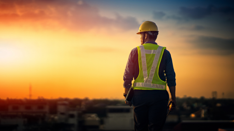 man in a hardhat walking off a worksite