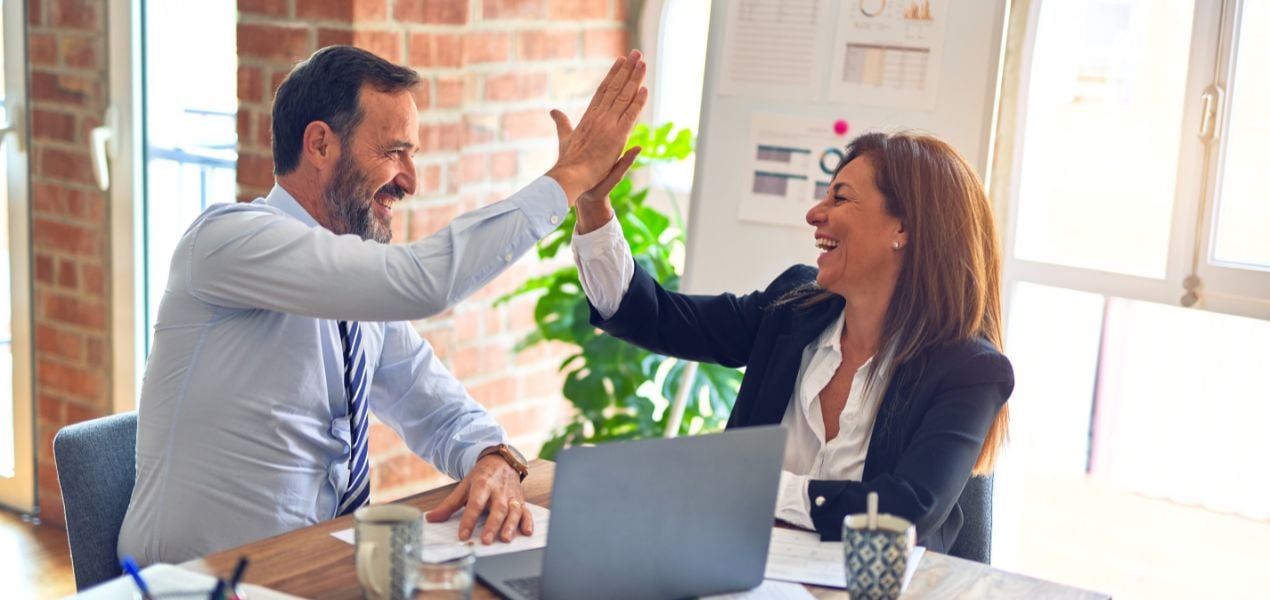 Two professionals high-fiving.