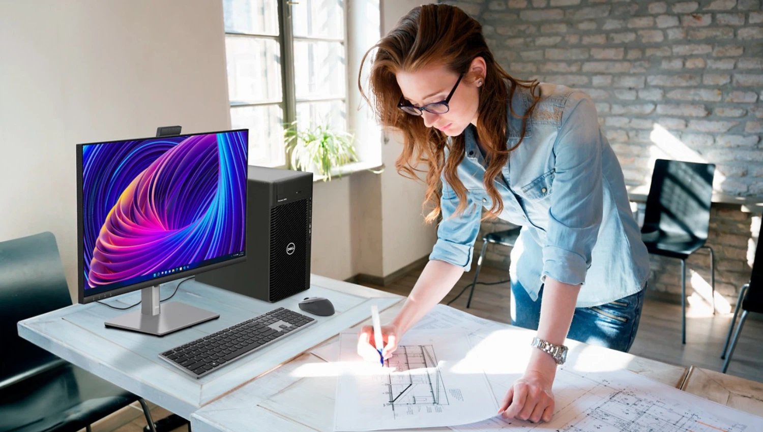 Small business owner with her Dell desktop computer in her office