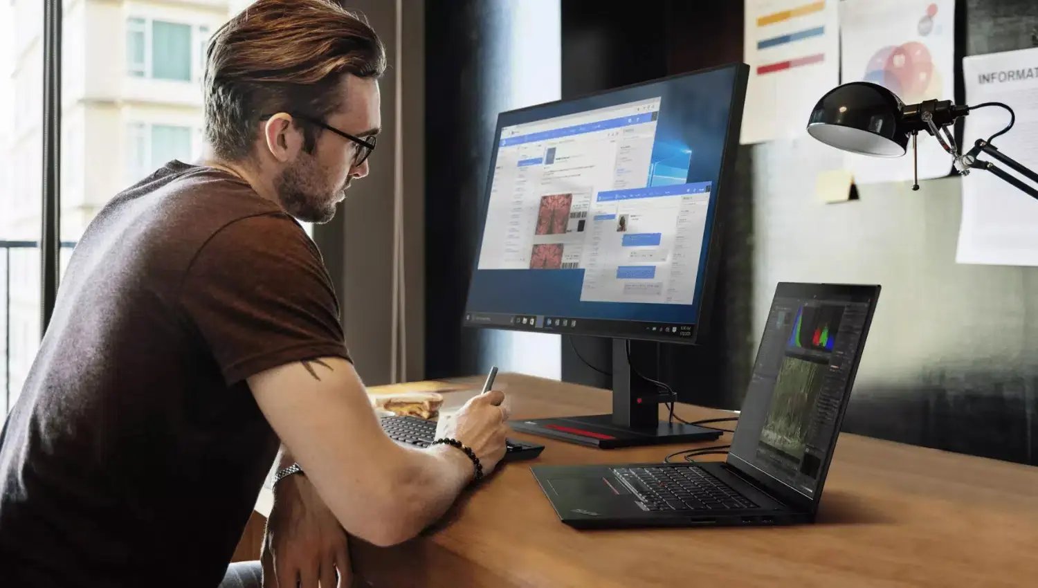 Small business owner working on his Lenovo computer in his office