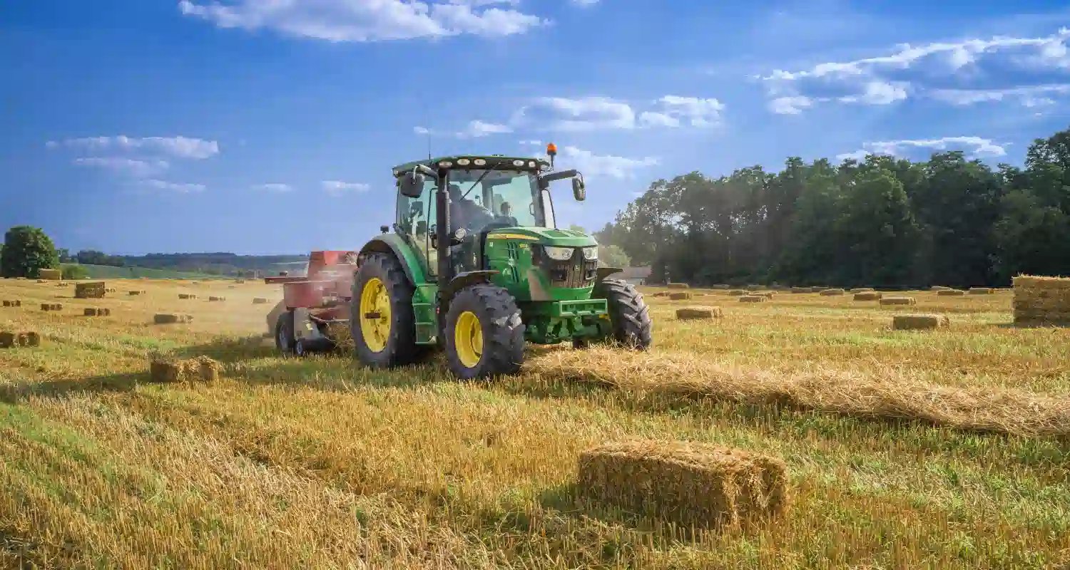 Small business owner on a tractor in a field