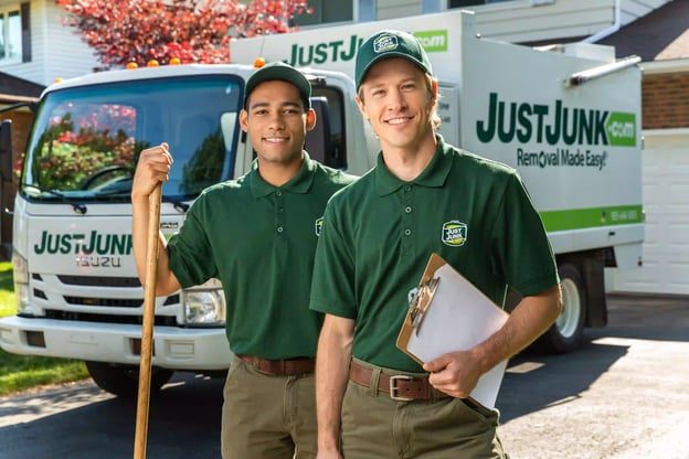 Two employees of Just Junk standing in front of their truck