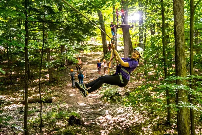 A girl ziplining in Arbraska