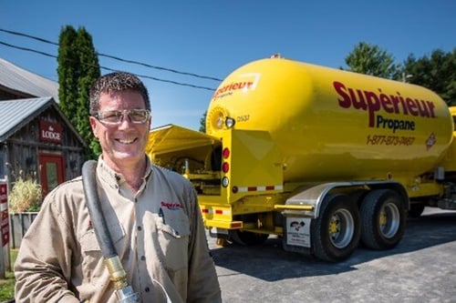 Employee of Superior Propane in front of a Superior Propane truck
