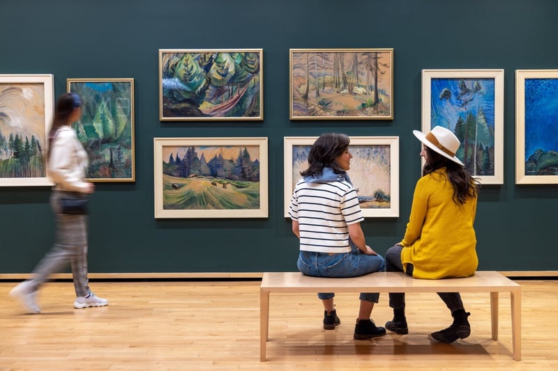 Two women speaking inside the Vancouver Art Gallery