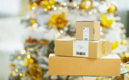 Shipping boxes stacked in front of Christmas tree