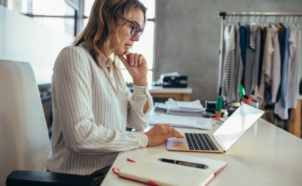 Small business owner reviewing her payroll on her laptops