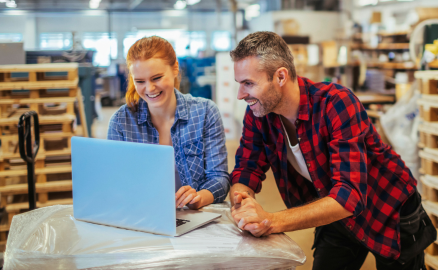 Two business owners reviewing work on their laptop