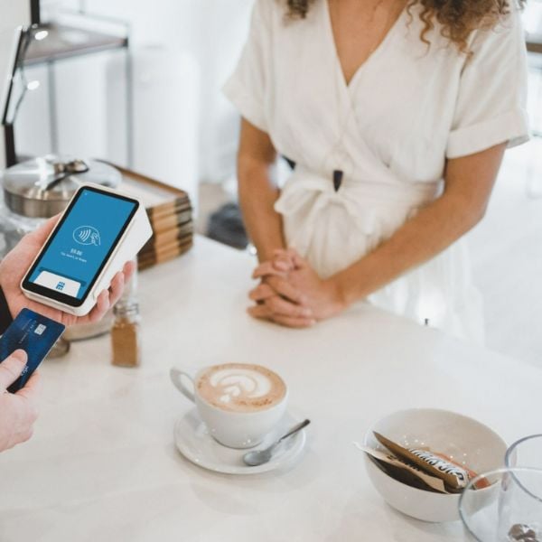 A small business owner accepting a credit card payment from a customer