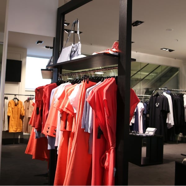 A vibrant array of women's clothing displayed in an independent boutique, showcasing a variety of styles and colors.
