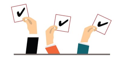 Three hands holding vote symbols