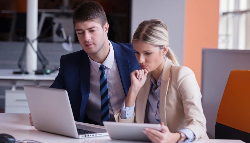 Two small business owners looking at their laptop