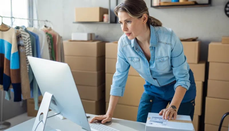 Small business owner checking her costs on her desktop