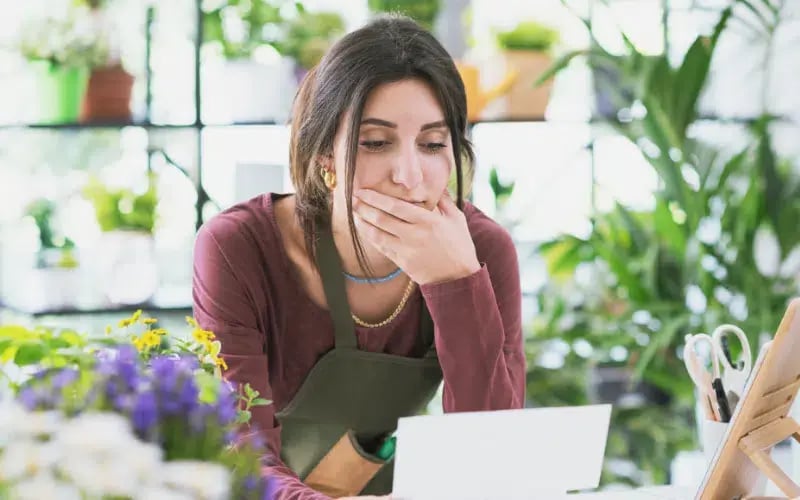 Small business owner looking at her laptop