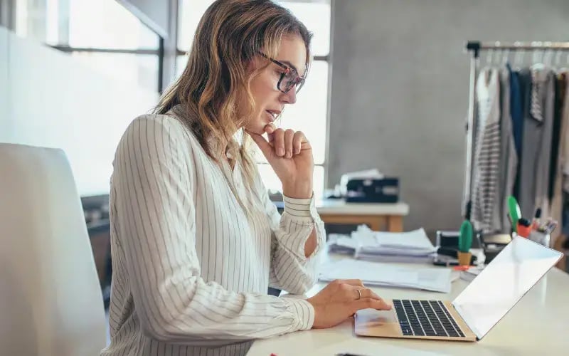 Small business owner looking at her laptop