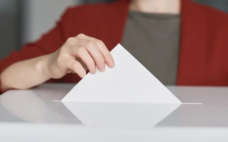 Small business owner casting her vote in the ballot box