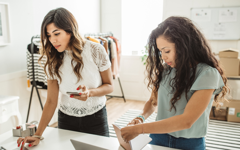 Two small business owners working in their store