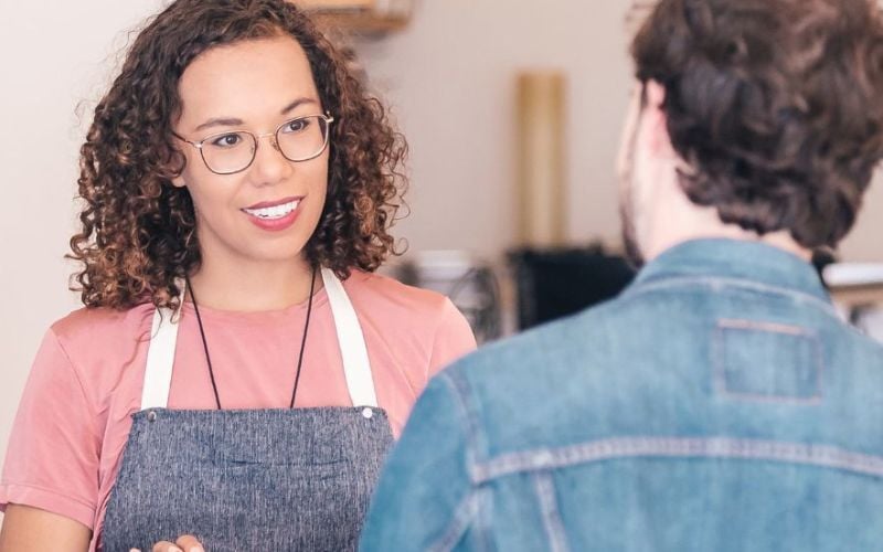 Small business owner with a customer in her store