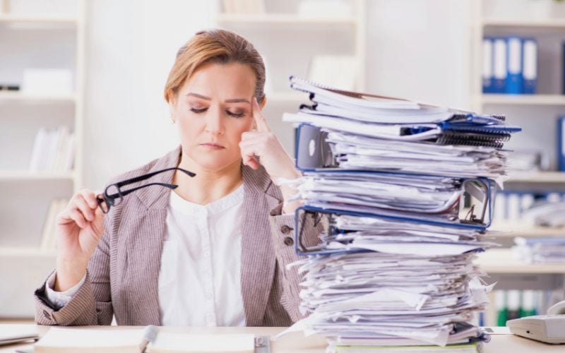 Small business owner overwhelmed by paperwork