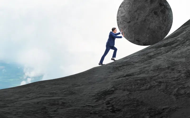 Small business owner pushing a stone symbolizing the weight of payroll tax on small business owners.