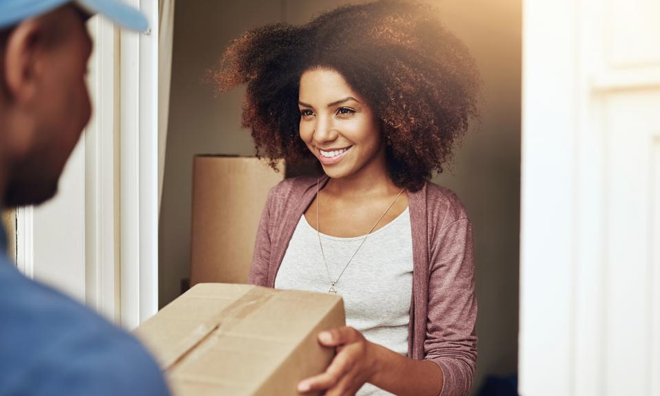 Happy customer receiving a shipment from a delivery person