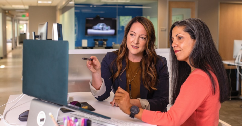 Two women looking at a computer