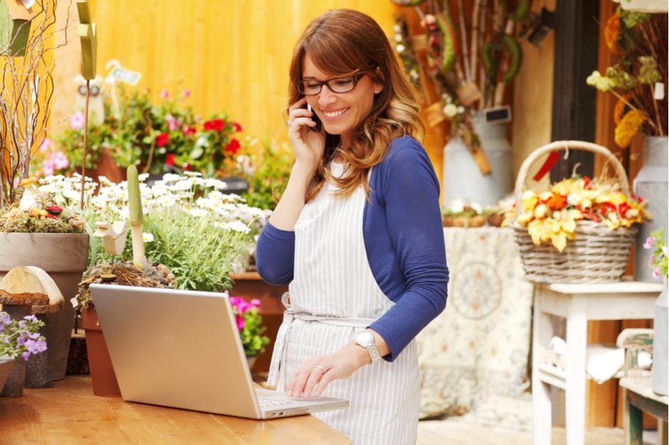 Woman talking on phone in flower shop
