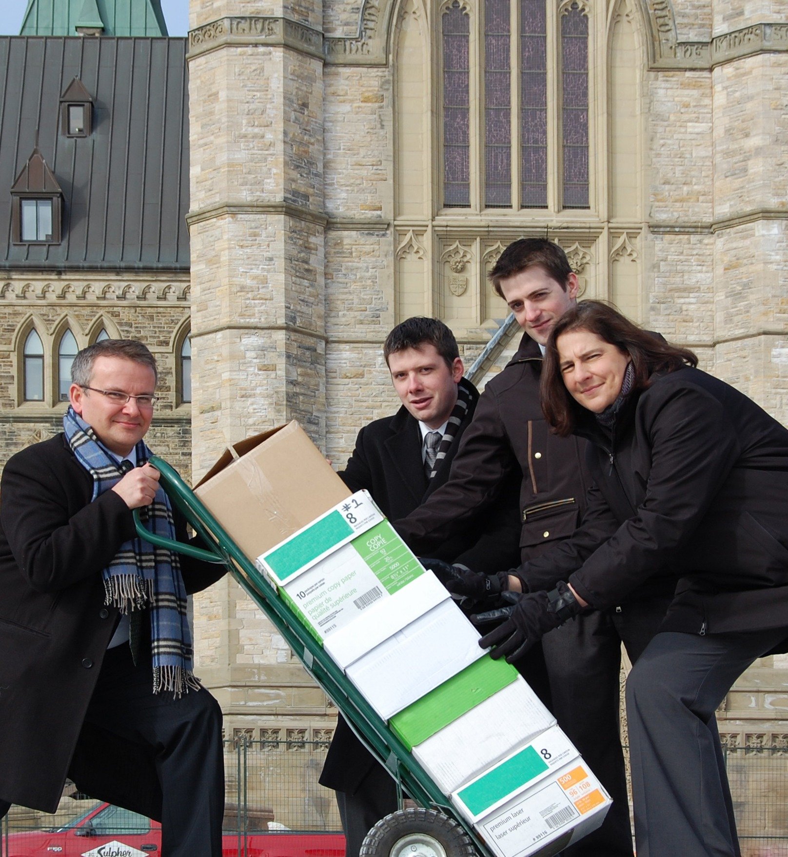 CFIB President Dan Kelly, Executive VP of Advocacy Corinne Pohlmann, and two colleagues hand delivering 50,000 signed petitions to parliament. 