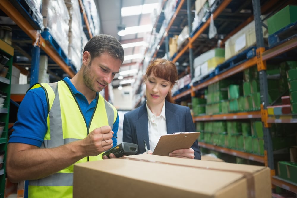 Manual worker and manager scanning package in the warehouse