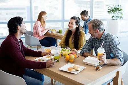 Work colleagues having a discussion over a healthy lunch