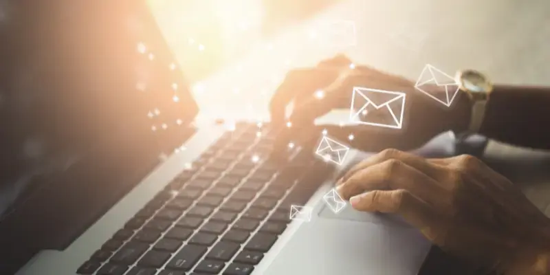 Email symbols around laptop