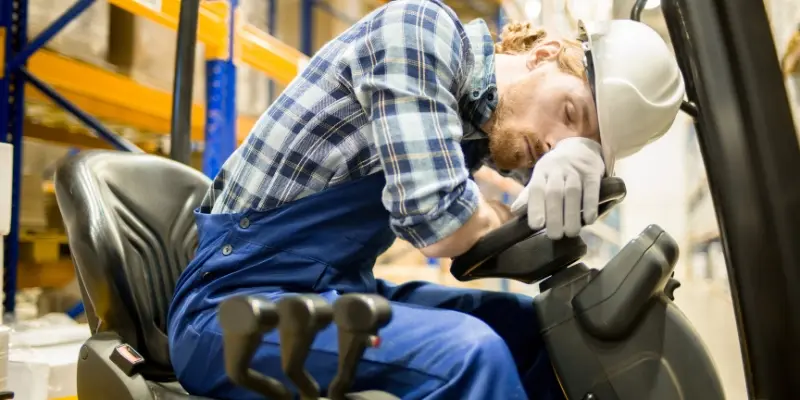 Worker falling asleep while driving a forklift