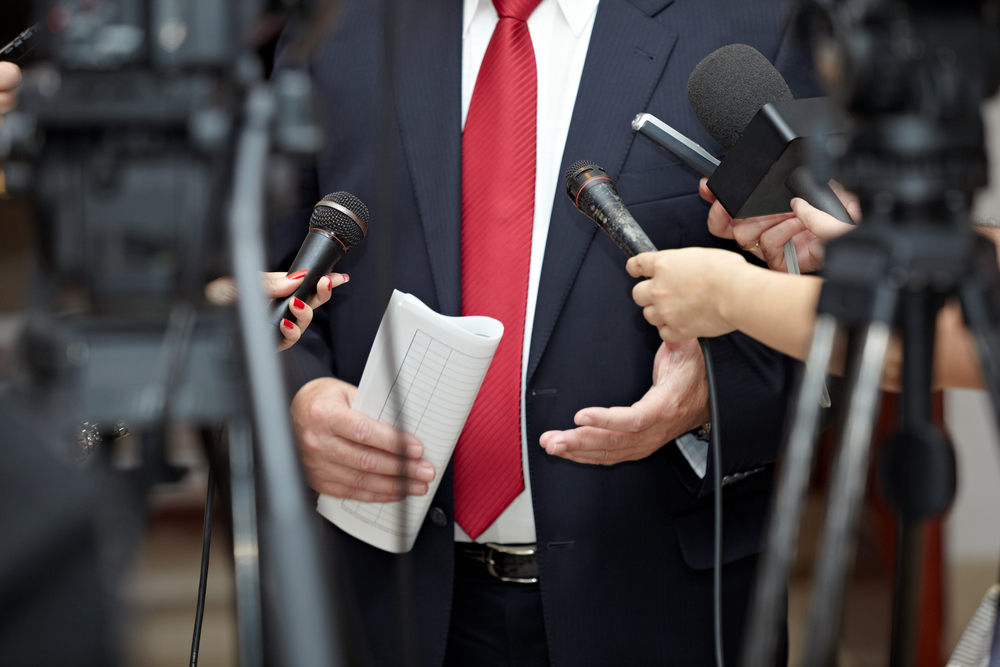 close up of conference meeting microphones and businessman