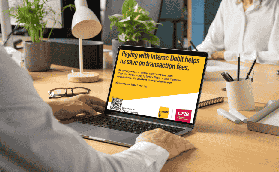 Small business owner reading CFIB's poster on his laptop