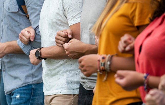 People hooked arm-in-arm