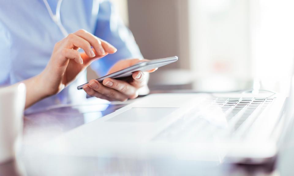 A woman using a calculator while managing her finances