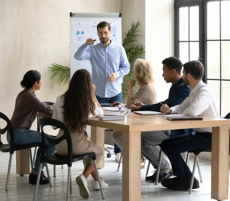 A small business owner in the middle of a training session for new employees