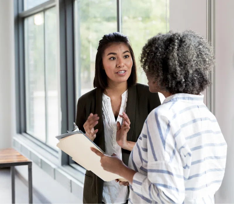 A manager of a small business company giving feedback to one of her employees