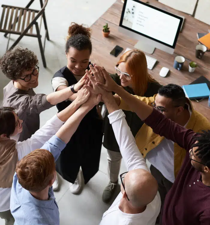 Employees of different race and colors joining hands