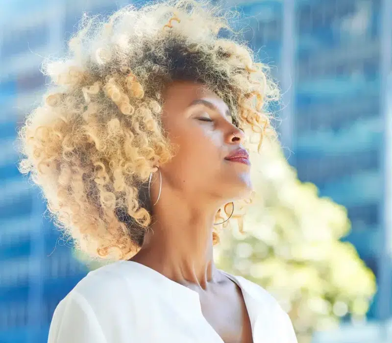 Small business owner relaxes outside her office