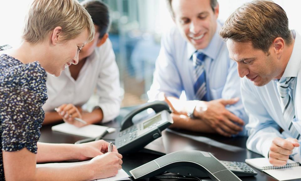 Buisness meeting at conference table with conference phone