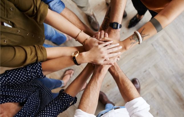 Group of people with their hands-in