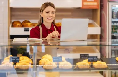 Small business owner working on her laptop in her pastry shop