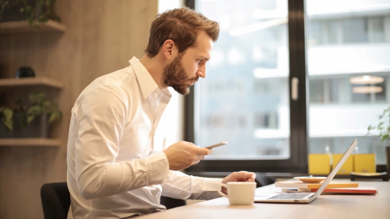 Small business owner checking his tax deductions on his laptop